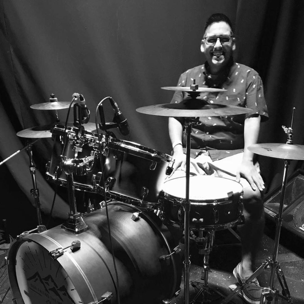 Irving Cuellar, Director of Musicianship & Rhythm sitting behind drum set